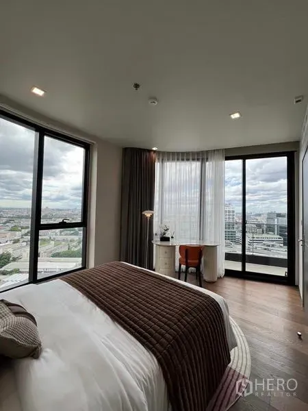 公寓 出租在Ratchathewi, Bangkok - 转角卧室，环窗与书桌角，享全景城市景致。