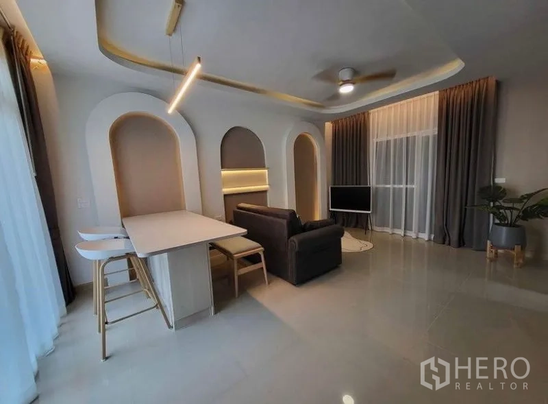 Townhouse for rent or sale - Open-plan living and dining with breakfast bar, pendant light, large glazing and glossy tile floors.