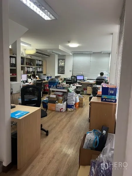 Retail Space for rent in Watthana, Bangkok - Office-style workspace with desks, shelving and wood flooring under fluorescent lighting.