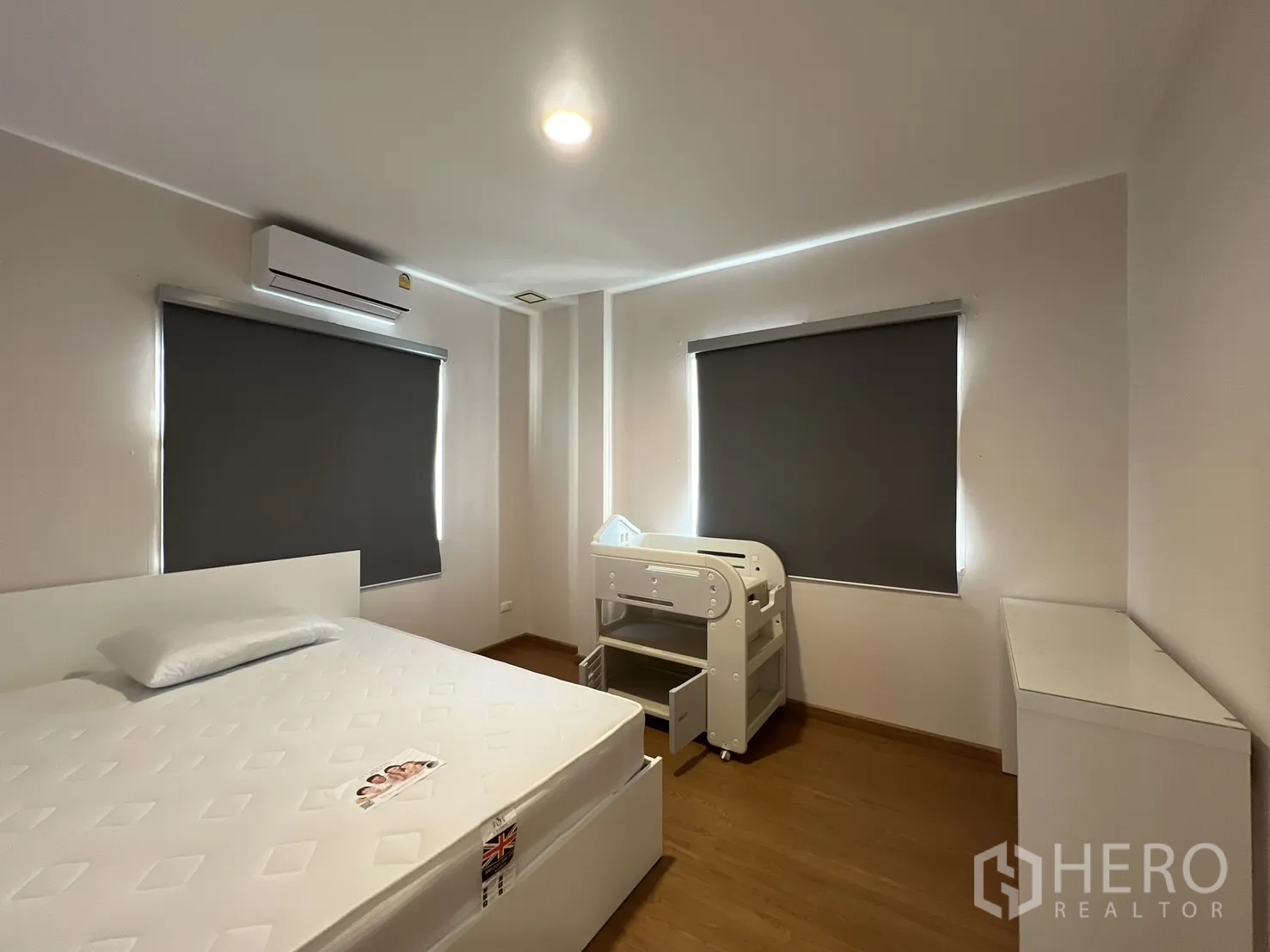 Detached House for rent in Bang Kapi, Bangkok - Bedroom angle showing bed, crib, and air conditioner.