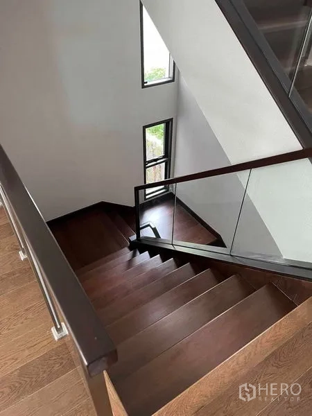 Detached House for sale in Bang Kruai, Nonthaburi - Stairwell with glass railing and side windows for natural light.