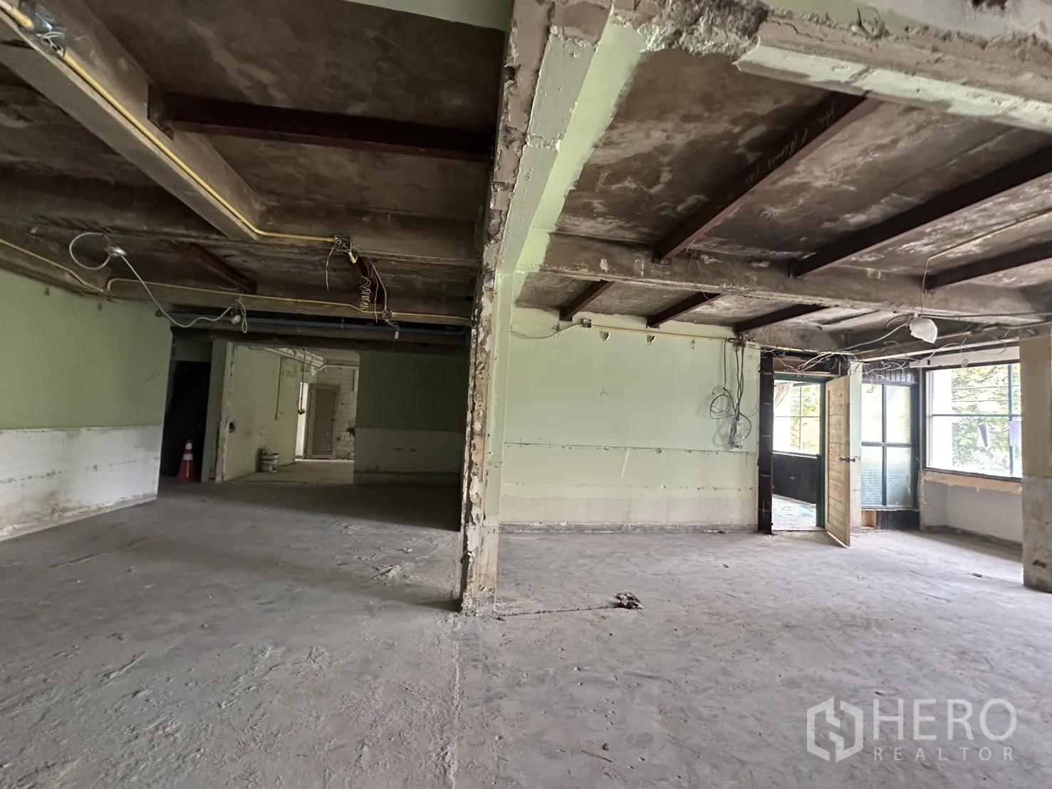 Office Space for rent in Bang Rak, Bangkok - Entrance zone showing exposed ceiling, visible wiring and an open timber door.