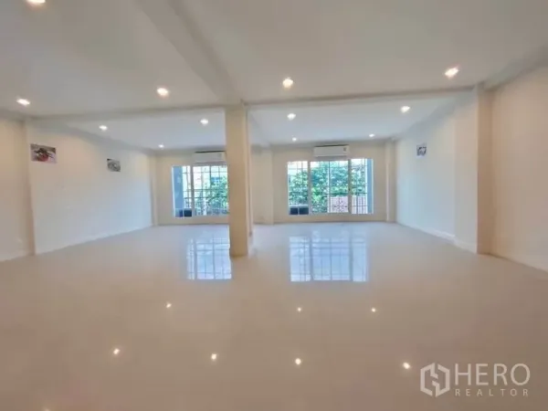 Home Office for rent or sale in Bang Na, Bangkok - Bright office level with large windows, split air-conditioners, and polished tile flooring.