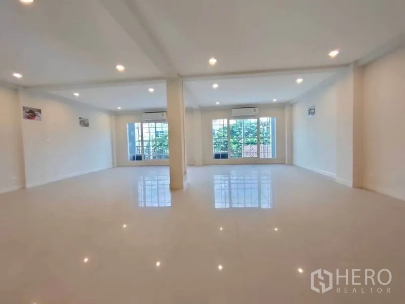 Home Office for rent or sale in Bang Na, Bangkok - Bright office level with large windows, split air-conditioners, and polished tile flooring.