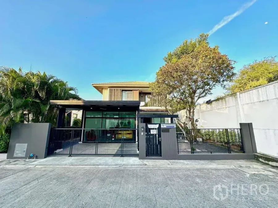 Detached House for sale in Bang Phli, Samut Prakan - Street-facing view of the detached house showing wide driveway and secure gate.