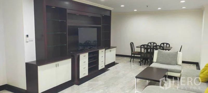 Condominium for rent in Watthana, Bangkok - Large entertainment wall with TV facing an open-plan dining area.