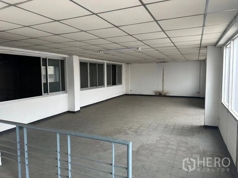 Factory for rent or sale in Khlong Luang, Pathum Thani - Open-plan mezzanine office with windows overlooking the factory.