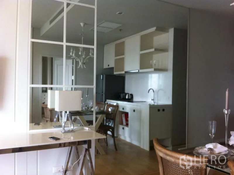 Condominium for rent in Bangkok - Mirrored feature wall and console table reflecting the kitchen and dining area.