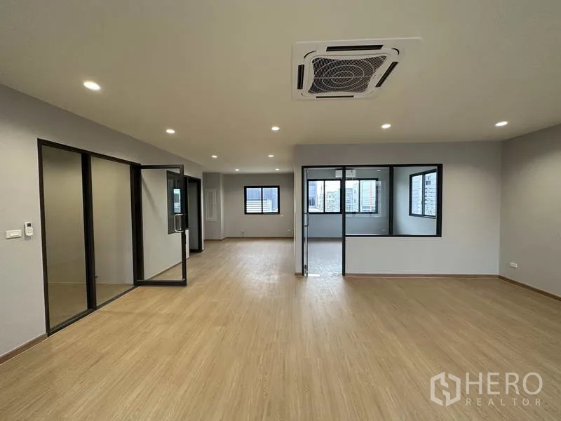 Factory for rent or sale in Lam Luk Ka, Pathum Thani - Upper-level office with wood-look flooring and framed glass meeting room.