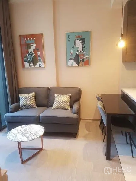 公寓 出租在Watthana, Bangkok - 室内面向落地窗与阳台，远眺城市天际线。