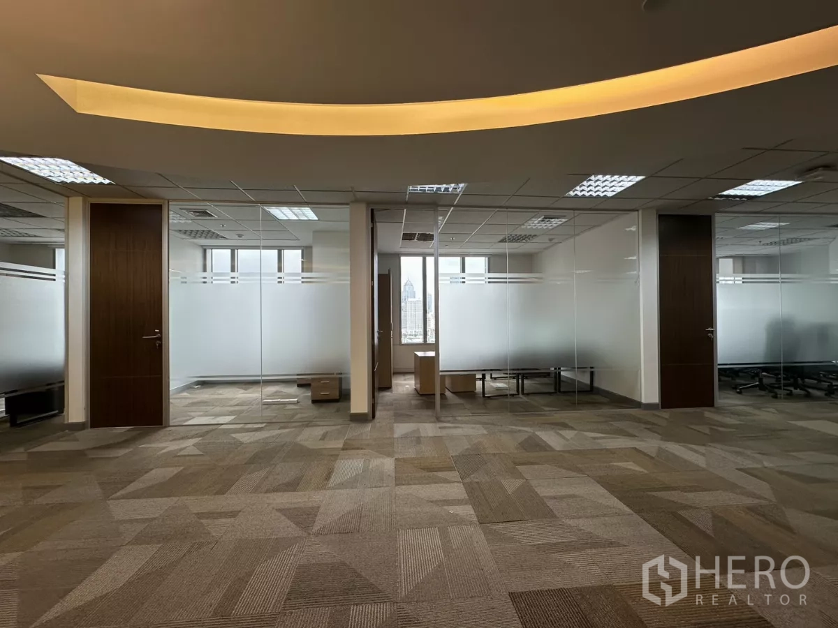 Office Space for rent in Watthana, Bangkok - Central office zone with cove lighting, geometric carpet and frosted-glass offices.