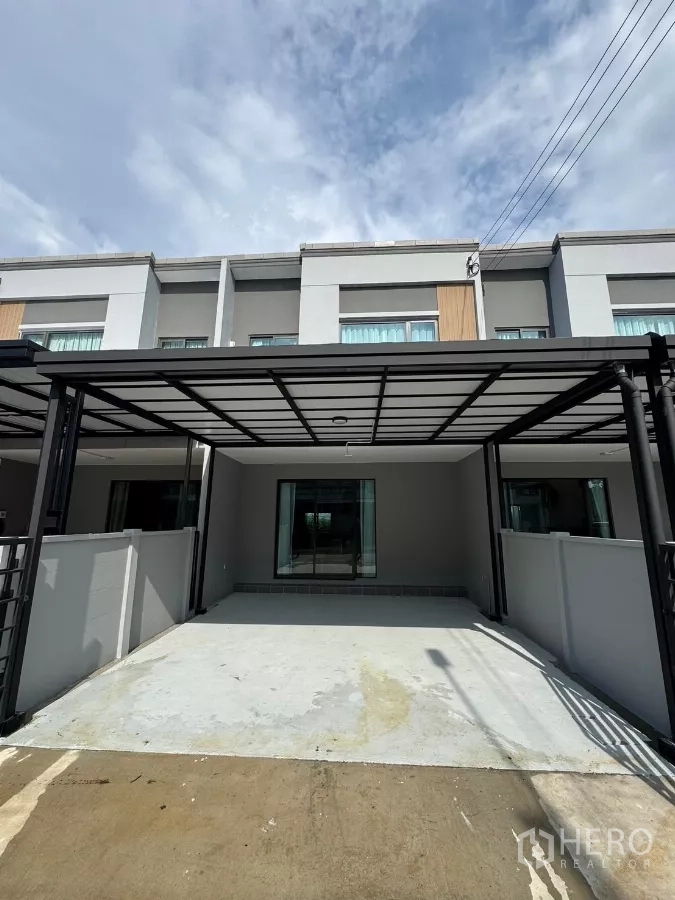Townhouse for rent in Bang Phli, Samut Prakan - Modern two-storey townhouse facade with covered two-car carport in Bang Phli, Samut Prakan.