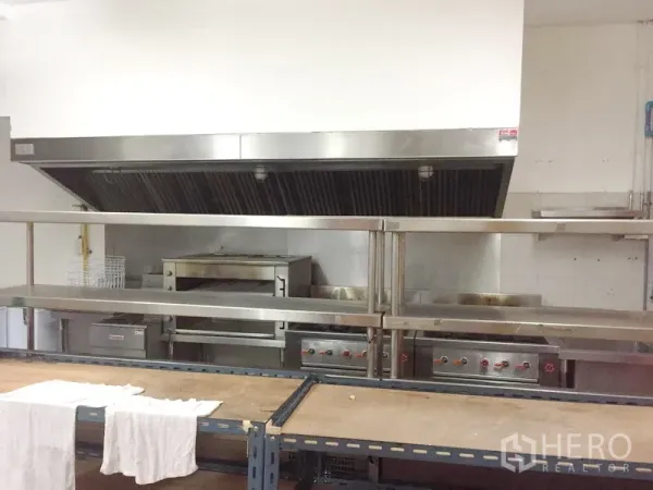 Retail Space for rent in Khlong Toei, Bangkok - Commercial kitchen line with stainless-steel exhaust hood, ovens and cooktops for restaurant use.