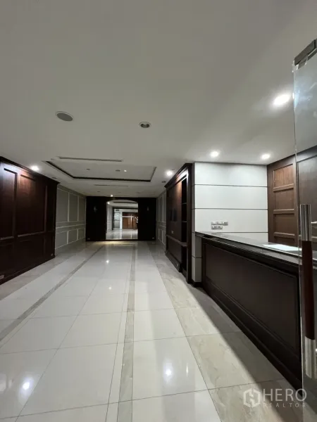 Office Space for rent in Watthana, Bangkok - Corridor with wood paneling and spotlights beside the reception.
