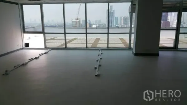 Office Space for rent in Khlong Toei, Bangkok - Open-plan office with floor-to-ceiling windows, terrace access, and Bangkok skyline view.