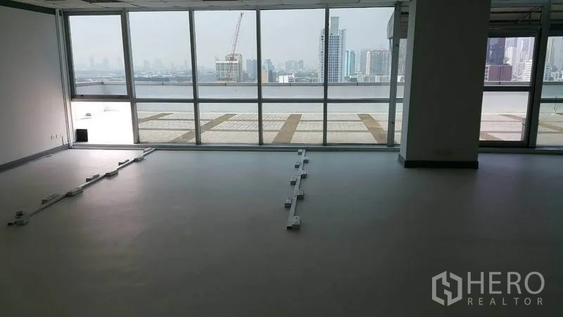 Office Space for rent in Khlong Toei, Bangkok - Open-plan office with floor-to-ceiling windows, terrace access, and Bangkok skyline view.
