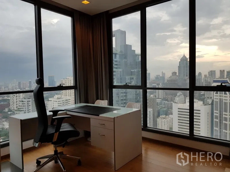 Condominium for rent in Watthana, Bangkok - Corner study with desk and executive chair facing city skyline