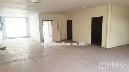 Warehouse for rent in Suan Luang, Bangkok - Bright office area inside the warehouse with tiled floor, partitioned rooms, and a large front window.