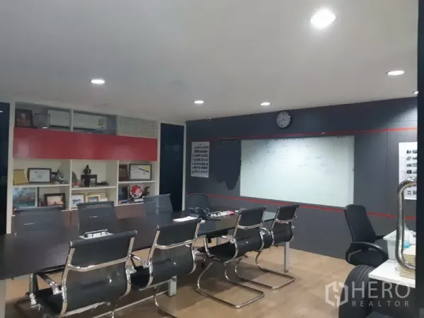 Office Space for sale in Khlong Toei, Bangkok - Modern meeting room with long conference table, executive chairs and a large whiteboard.