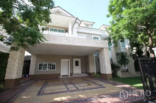 Detached House for rent or sale - Grand detached house exterior with stone-clad columns, covered two-car carport, gate and mature trees.