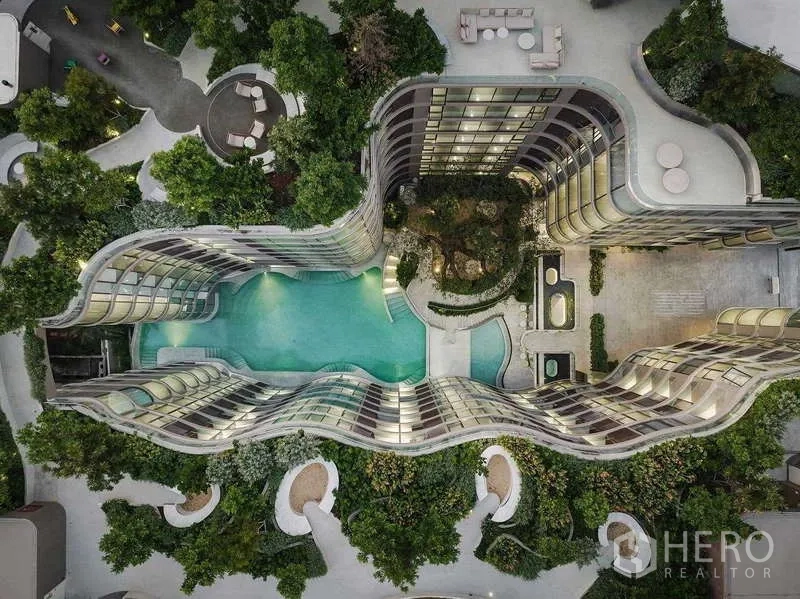 Condominium for rent - Aerial view of the curving Fynn Asoke towers surrounding a resort‑style swimming pool and gardens.