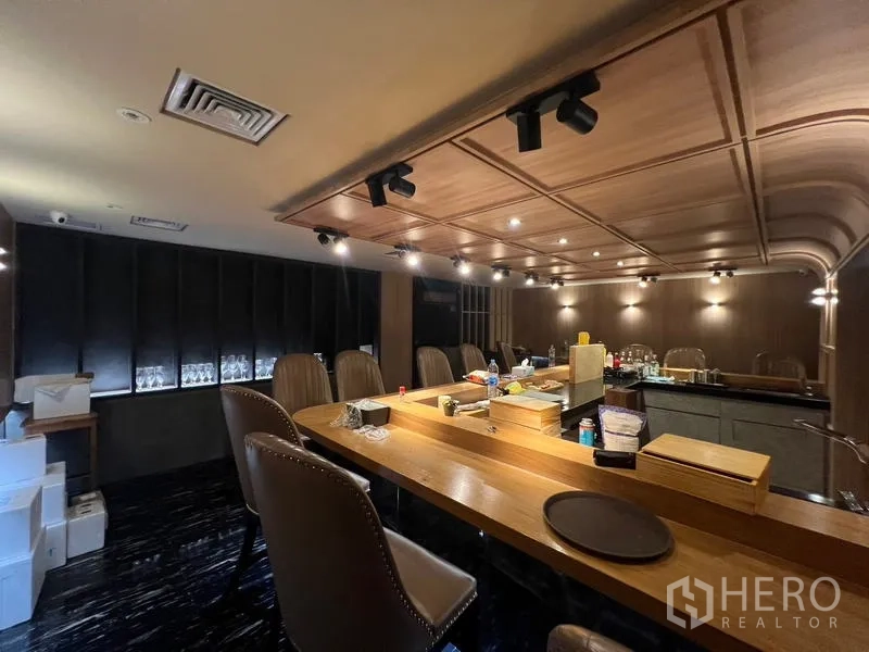 Retail Space for rent in Bang Rak, Bangkok - Wide view of bar counter and seating under recessed and track lights.