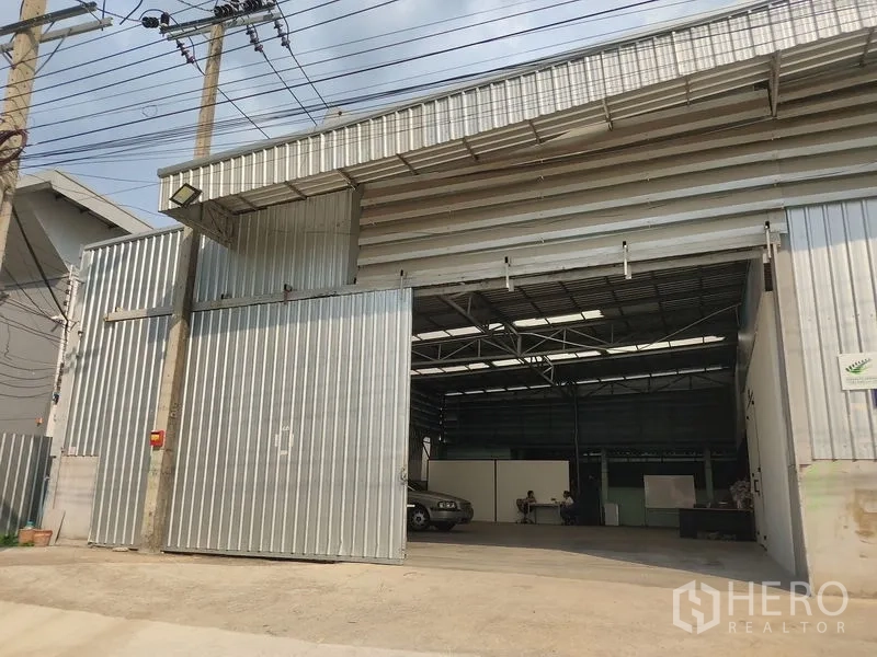 Warehouse for rent in Bueng Kum, Bangkok - Front facade of the warehouse with large sliding metal doors and wide vehicle access.
