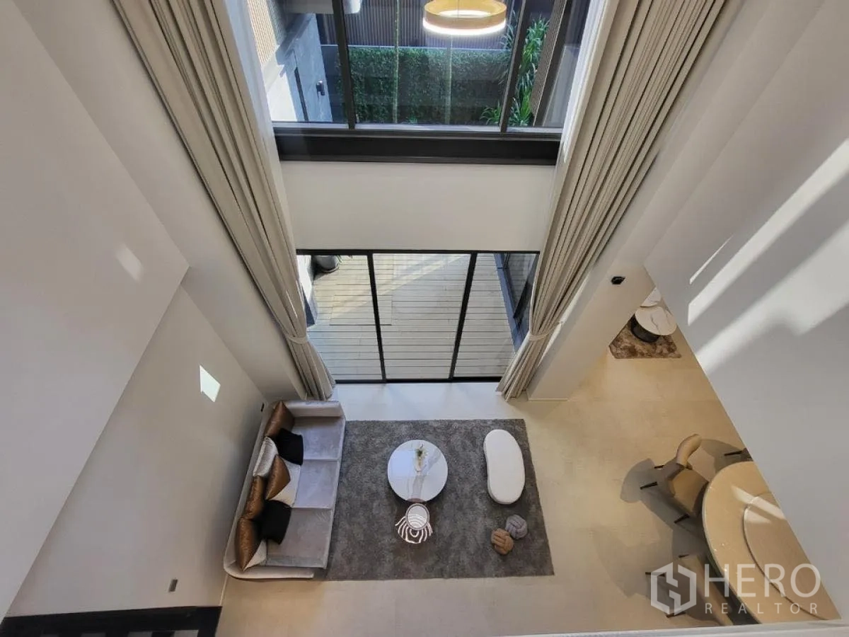 Detached House for rent in Wang Thonglang, Bangkok - View from the upper floor over the double-volume living area and terrace.