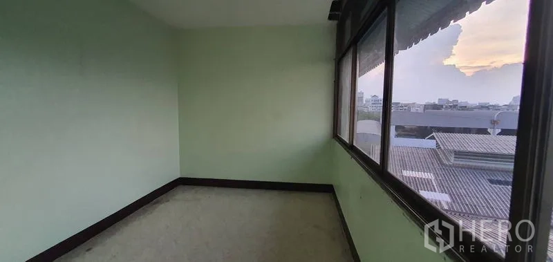 Warehouse for rent in Bang Kho Laem, Bangkok - Corner office with wraparound windows and city skyline views.