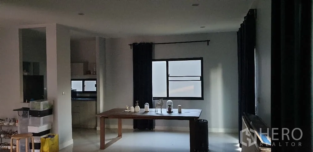 Detached House for rent or sale in Lam Luk Ka, Pathum Thani - Open dining area with long wooden table near windows.