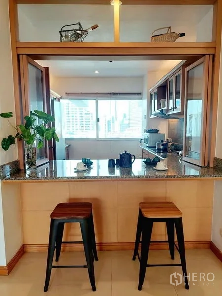 Apartment for rent - Granite breakfast counter with two stools overlooking the enclosed kitchen.