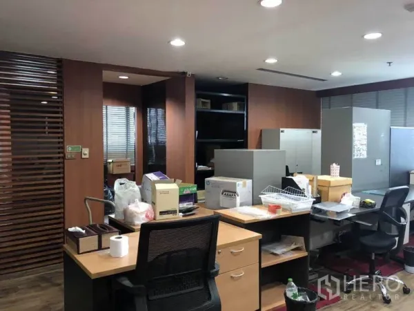 Office Space for sale in Watthana, Bangkok - Open office area with desks, wooden slat partitions, and ceiling lights.