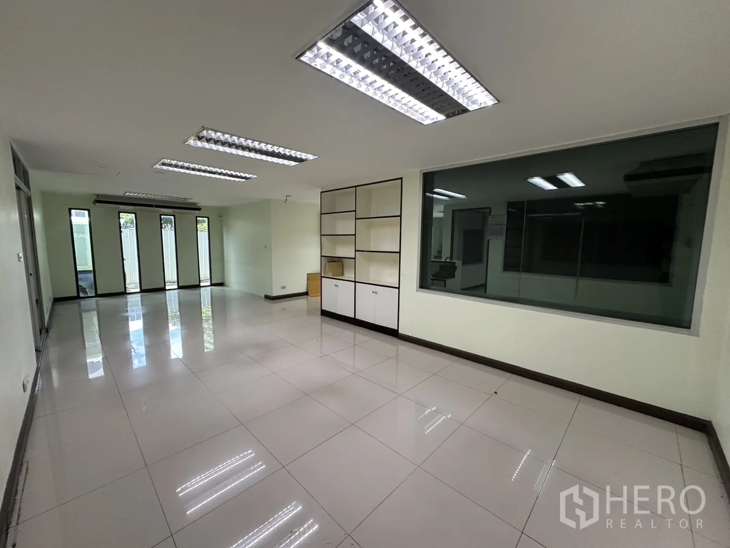 Retail Space for rent in Watthana, Bangkok - Spacious multipurpose room with glossy tiles and recessed lighting.