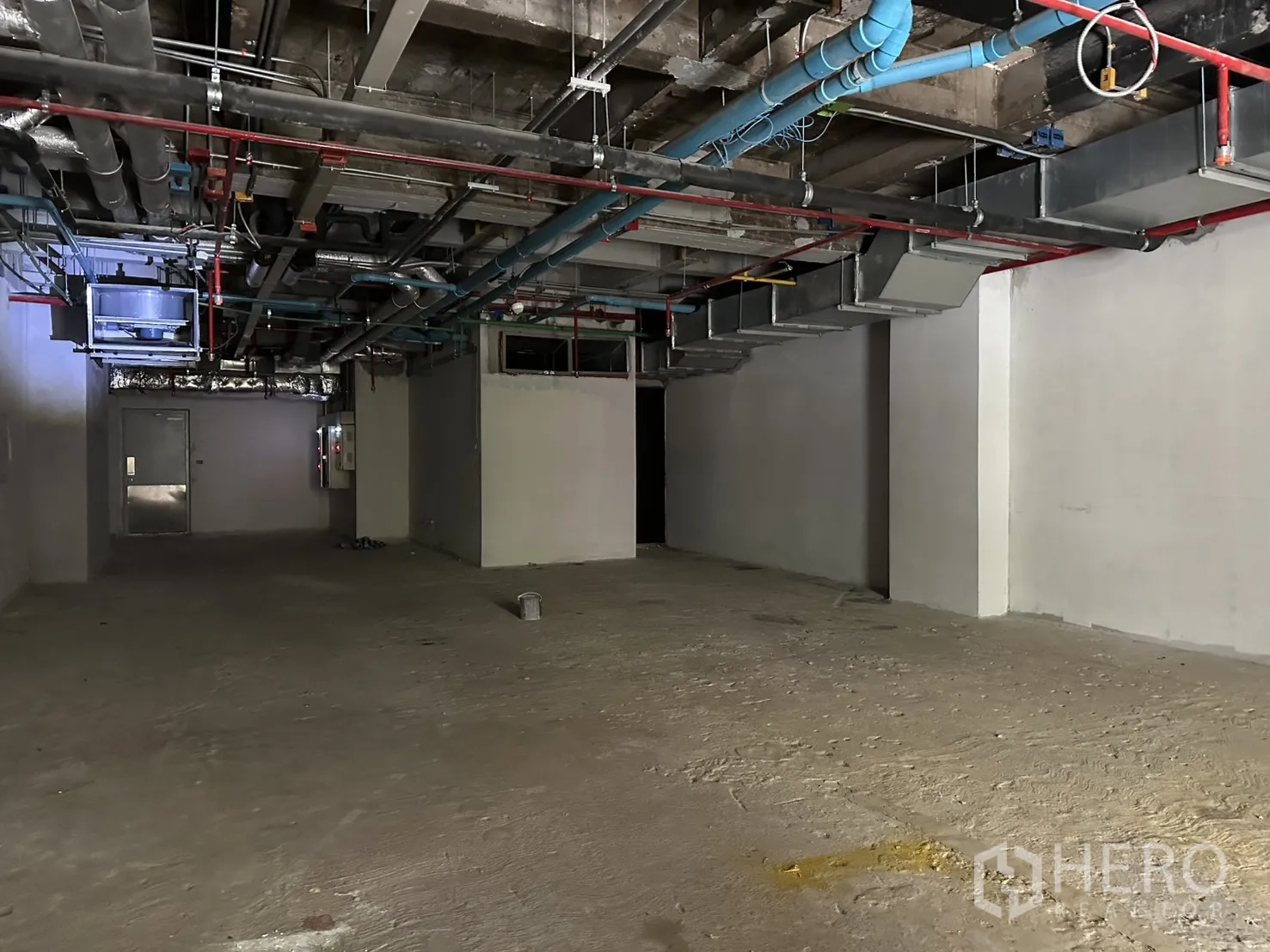 Retail Space for rent in Bang Rak, Bangkok - Open-plan shell space with white walls and visible ceiling mechanical systems.