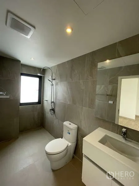 Home Office for rent in Don Mueang, Bangkok - Contemporary bathroom with gray tiles, shower area, vanity and toilet.