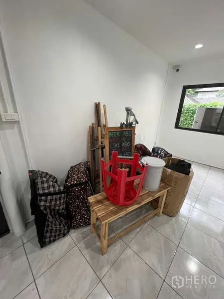 Retail Space for rent in Khlong Toei, Bangkok - Back room with white walls, tiled floor and a black-framed window.