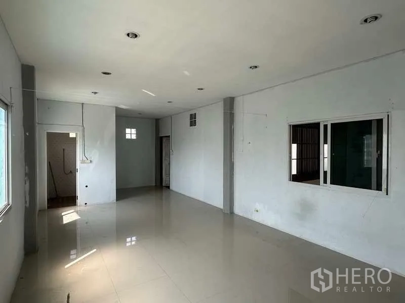 Warehouse for rent in Pathum Thani - Alternate view of the upper office with recessed lights and glossy tile floor.