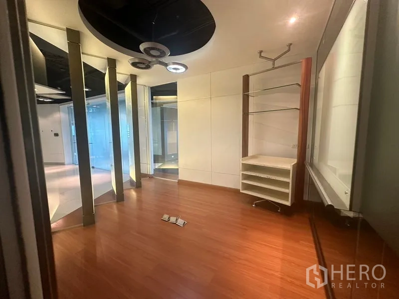Office Space for rent in Khlong Toei, Bangkok - Small meeting room with wood flooring, shelving and feature ceiling lights.