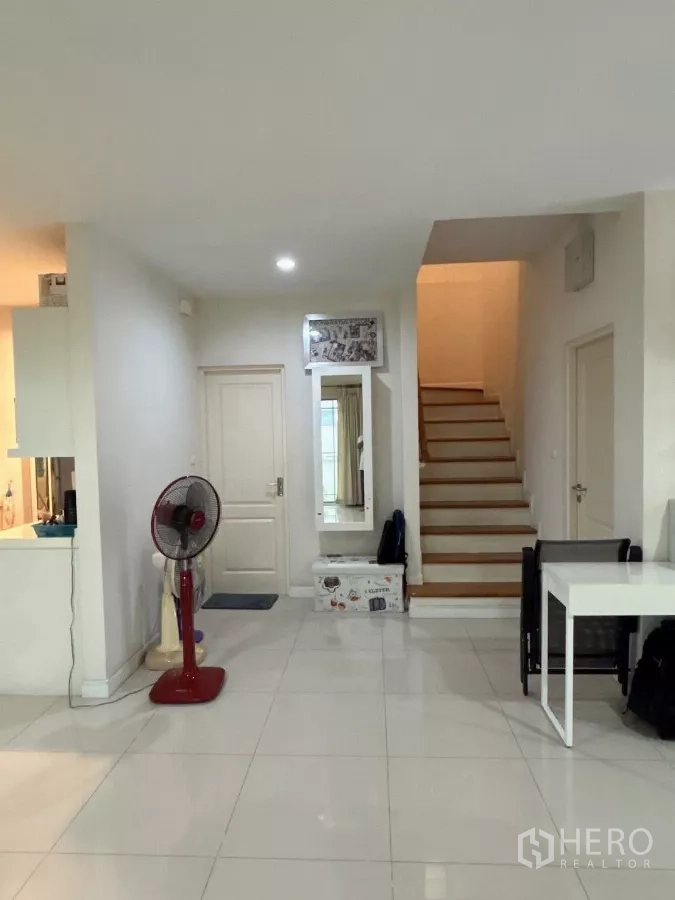Detached House for sale in Bang Kapi, Bangkok - Ground-floor hall with staircase to the upper level and white interior doors.