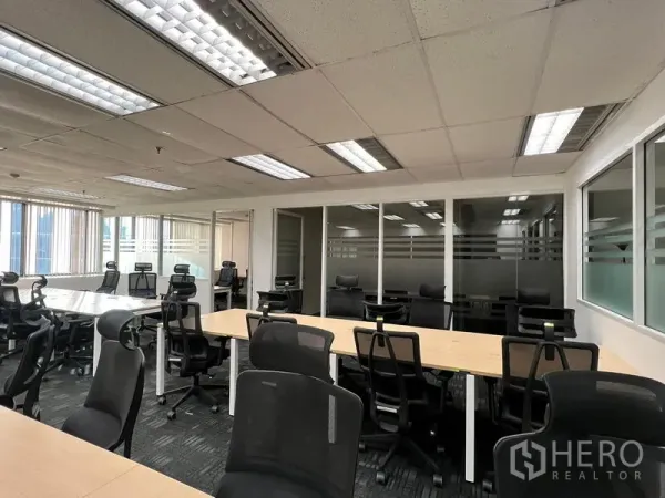 办公空间 出租在Khlong Toei, Bangkok - 工位与人体工学椅，玻璃隔断办公室，格栅吊顶灯照明。