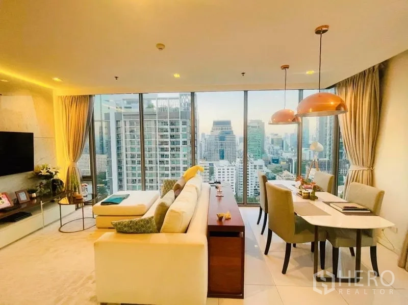 Condominium for rent or sale in Sathon, Bangkok - Living and dining space with panoramic city views from full-height glass walls.