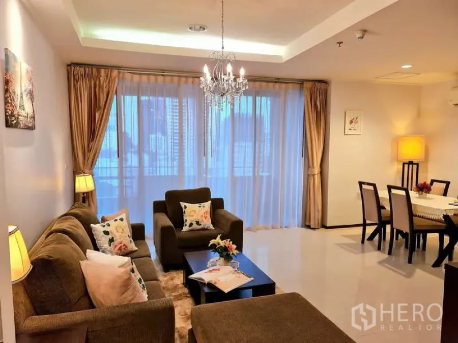 Apartment for rent - Living and dining space opening to sliding glass doors with city skyline behind sheer curtains.