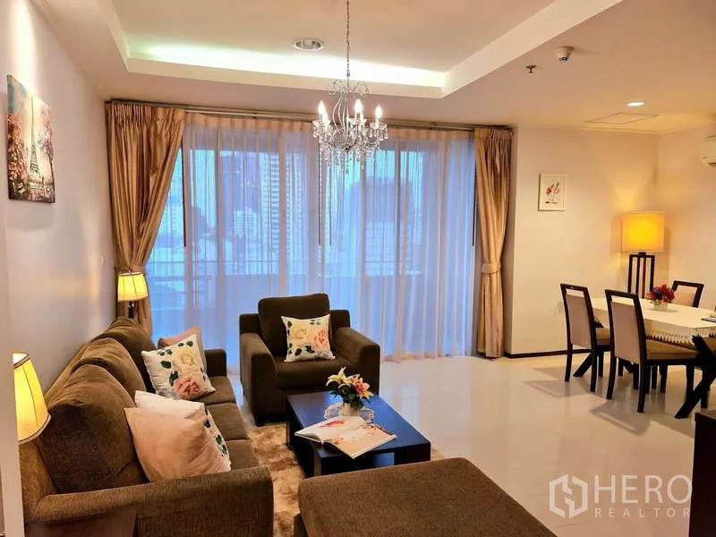 Apartment for rent - Living and dining space opening to sliding glass doors with city skyline behind sheer curtains.