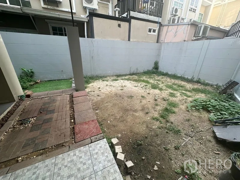 Home Office for rent in Bang Na, Bangkok - Private walled backyard with mixed paving and open soil ready for landscaping.