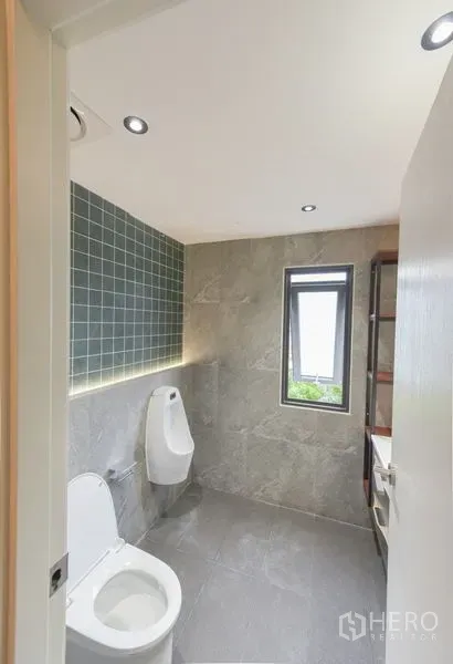 Home Office for rent or sale - Renovated bathroom with gray tiles, window and wall-mounted fixtures.