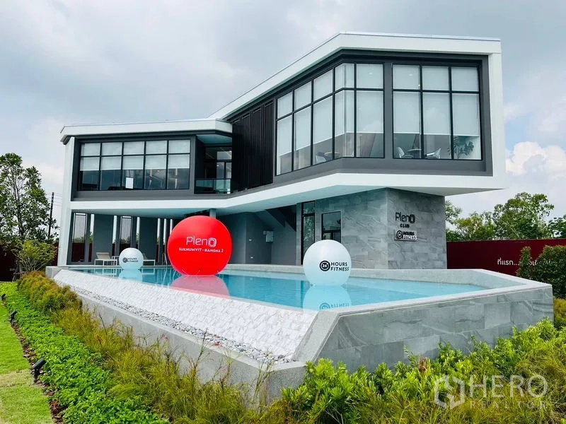 Townhouse for rent - Modern clubhouse with swimming pool and landscaped surroundings.