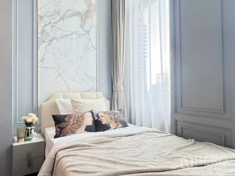Condominium for rent in Watthana, Bangkok - Sunlit bedroom with marble accent headboard, tall windows and a glimpse of the city view.