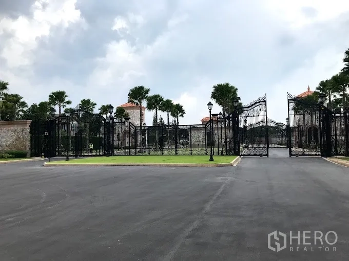 Detached House for rent or sale in Bang Khen, Bangkok - Secure gated community entrance with ornate iron gates.