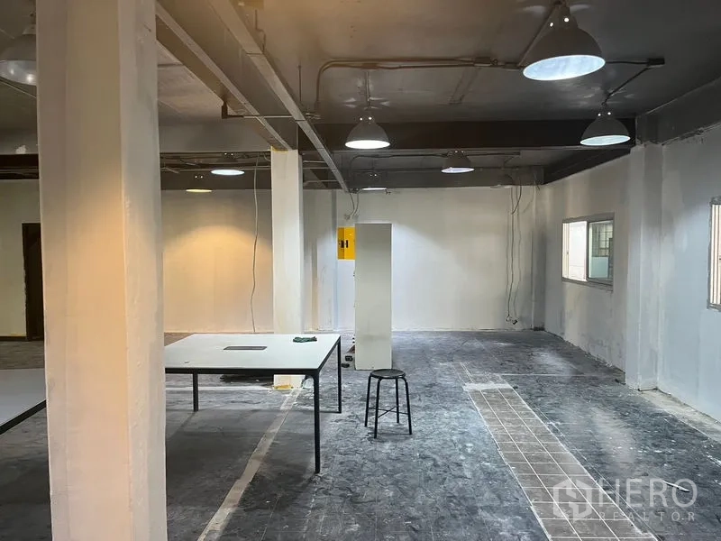 Retail Space for rent in Pathum Wan, Bangkok - Retail shell space with tiled walkway detail, exposed conduits, and freestanding stool.