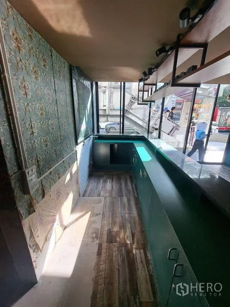 Retail Space for rent in Bang Rak, Bangkok - Compact back-of-house prep area with counters, windows, and storage shelves.